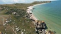 Flying along deserted empty uninhabited sand and stone beach of a tropical island. Shot. Aerial view of a sea coast with Royalty Free Stock Photo