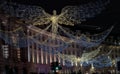 Flying angel Christmas decoration led lights display. Dramatic view of the traditional Christmas decoration lights hanging above
