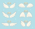 Flying angel wings with gold nimbus. Angelic wing cartoon vector set