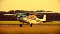 Flying antique biplane performs stunt at airshow in sunset generated by AI