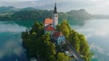 Flying around small island on Bled Lake in Slovenia. Aerial view of Church of the Assumption of Mary in the center of Royalty Free Stock Photo
