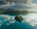 Flying around small island on Bled Lake in Slovenia. Aerial view of Church of the Assumption of Mary in the center of Royalty Free Stock Photo
