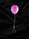 Flying balloon with gallows rope, noose or hangman knot on black background. Abstract creative emotional concept of suicide Royalty Free Stock Photo