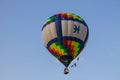 Flying balloon with passengers in a basket against the blue sky at the festival of Aeronautics summer evening in Pereslavl-Zalessk