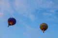 Flying balloon with passengers in a basket against the blue sky at the festival of Aeronautics summer evening in Pereslavl-Zalessk