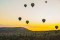 Flying on the balloons early morning in Cappadocia. Colorful spring sunrise in Red Rose valley, Goreme village location