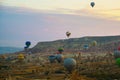 Flying on the balloons early morning in Cappadocia. Colorful spring sunrise in Red Rose valley, Goreme village location