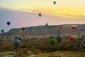 Flying on the balloons early morning in Cappadocia. Colorful spring sunrise in Red Rose valley, Goreme village location, Turkey,