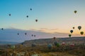 Flying on the balloons early morning in Cappadocia. Colorful spring sunrise in Red Rose valley, Goreme village location, Turkey,