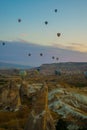 Flying on the balloons early morning in Cappadocia. Colorful spring sunrise in Red Rose valley, Goreme village location, Turkey,