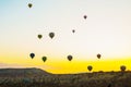 Flying on the balloons early morning in Cappadocia. Colorful spring sunrise in Red Rose valley, Goreme village location, Turkey,