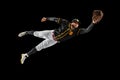 Flying. Baseball player, catcher in sports uniform and equipment practicing isolated on a black studio background. Team