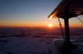 Flying a biplane at sunset