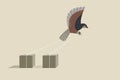 A bird tied to solid blocks trying to fly away. Concept of freedom