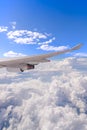 Flying into blue sky and sea of clouds and Wing of airplane with Royalty Free Stock Photo