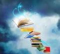 Flying books with fairytales and magic lights on background. Creative design Royalty Free Stock Photo