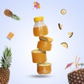 Flying bottle of fresh pineapple juice cut into slices on a pastel blue background. Creative fruit mockup Royalty Free Stock Photo