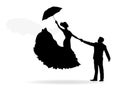 Silhouette of a groom holding his bride. She is flying with an umbrella.