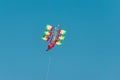 Flying a bright colored kite in the blue sky. The concept of free flight Royalty Free Stock Photo