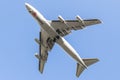 Flying Cargolux Boeing B747 airplane in underneck view with blue sky