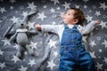 Flying child in the starry sky. Funny baby on a blue starry background