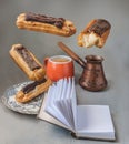 Flying chocolate eclairs near cup with espresso and coffee pot