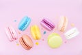 Flying colorful macaron or macaroon on pink pastel background.