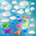 Flying colorful paper airplanes with clouds on the blue b Royalty Free Stock Photo