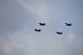 Flying combat aircraft against the blue sky with clouds on a sunny day