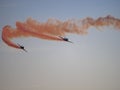 Flying combat aircrafts with pink traces in the sky