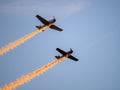 Flying combat aircrafts with yellow traces in the sky