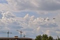 Flying combat helicopters against a blue sky with clouds on a sunny day