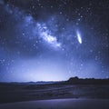 A flying comet against the background of the night starry sky with numerous constellations, a view in a semi-desert