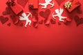 Flying cupid silhouette with hearts, gifts, happy Valentine`s Day banners, paper art style. Amour on red paper Royalty Free Stock Photo