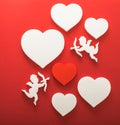 Flying cupid silhouette with hearts, happy Valentine`s Day banners, paper art style. Amour on red paper