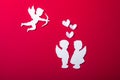 Flying cupid silhouette, two white angel, happy Valentine`s Day banners, paper art style. Amour on red paper