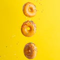 Flying donuts. Many donuts with colored caramel with sprinkles on a yellow background. Vertical photo. Freezing in motion