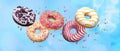 Flying doughnuts. Sweet and colourful donuts on blue background