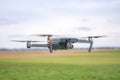 A flying drone against a cloudy sky in cloudy weather takes pictures of the surface of the earth