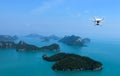 Flying Drone camera or UAV in the blue sky with ocean and island Royalty Free Stock Photo