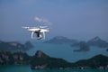 Flying Drone camera or UAV in the blue sky with ocean and island Royalty Free Stock Photo