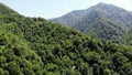 flying drone over green mountains with trees landscape, top view from above, aerial shot, inspirational wonderful nature Royalty Free Stock Photo