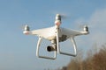 Flying drone quadcopter Dji Phantom 4 with high resolution digital camera. Royalty Free Stock Photo