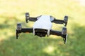 Flying drone with video camera with blurred green background Royalty Free Stock Photo