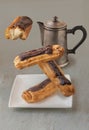 Flying eclairs and a coffee pot on a gray background