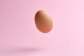 Flying egg on pink background. Happy easter concept Royalty Free Stock Photo