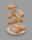 Flying delicate eclairs against gray background