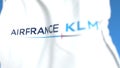 Flying flag with Air France KLM logo, close-up. Editorial 3D rendering