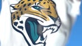 Flying flag with Jacksonville Jaguars team logo, close-up. Editorial 3D rendering