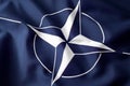 Flying flag of the North Atlantic Treaty Organization NATO intergovernmental military alliance concept for worldwide defensive